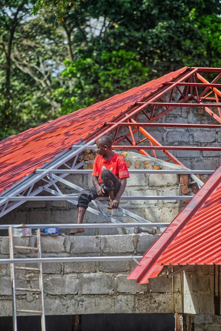 Operario trabajando en la estructura de una cubierta roja